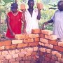 Three masons bussy raising up the new school walls, on the built foundations...from left is Mr. Mwenda, next is Joseph and on the right is Mr. Bonge.